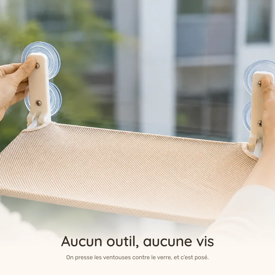 No tools, no screws — two hands press the suction cups of the platform against the glass