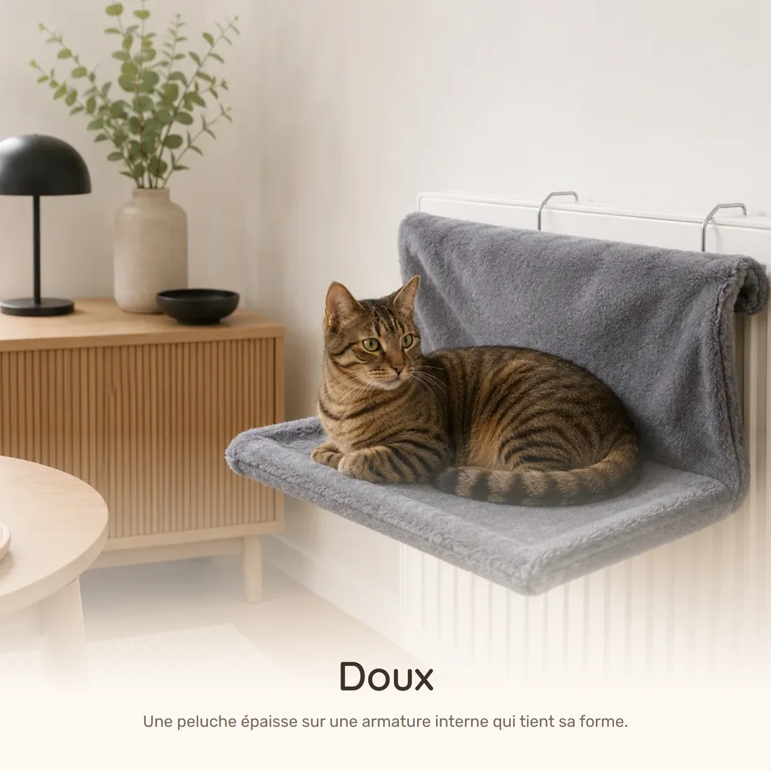 Soft — the plush radiator hammock hooked onto a radiator, a tabby cat settled in it
