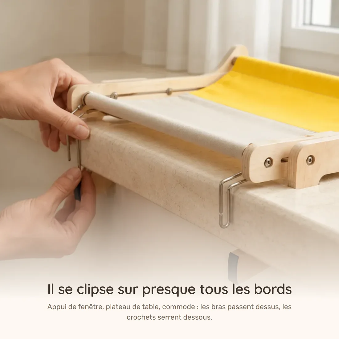 It clips onto almost any ledge — two hands engage the hooks of the wooden frame hammock under a window sill