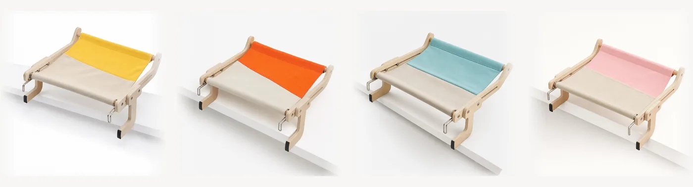 The four colors of the wooden-frame perch in a row on a studio background: yellow, orange, teal and pink canvas on an identical frame